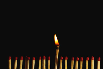 Burning matches on dark background