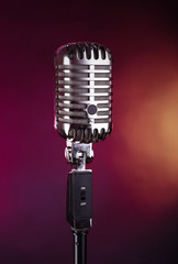 Fototapeta na wymiar Retro microphone on colorful blurred background