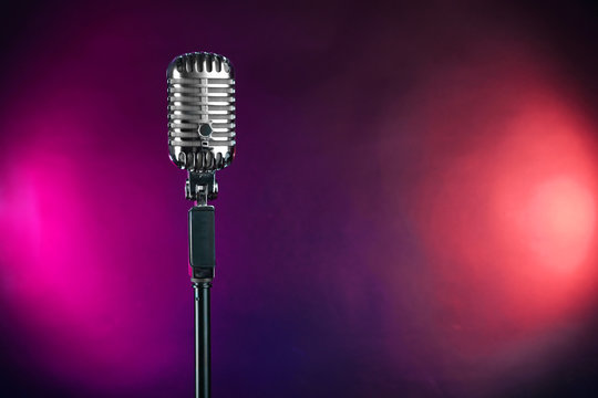 Retro microphone on colorful blurred background