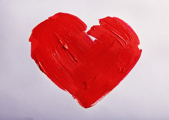 Painted red heart on white paper background