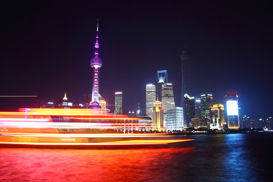 Boat passing in front of the modern Pudong district of Shanghai