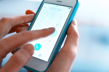Finger touch number on smartphone to make a call, close up