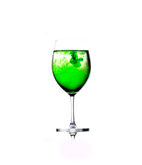 Green drops in a glass of water