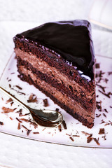 Piece of chocolate cake on white plate, closeup