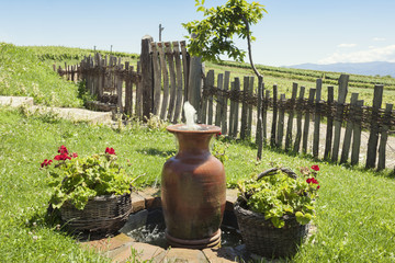 Jar shaped fountain in rural house lawn