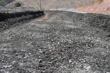 The building is covered with crushed rock and asphalt.