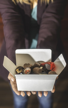 Hands Holding A Box Of Chocolates