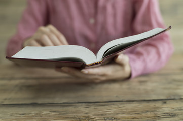 Woman is reading a thick book