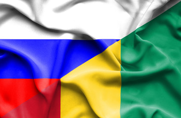 Waving flag of Guinea and Russia