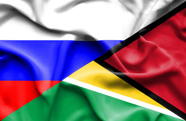 Waving flag of Guyana and Russia