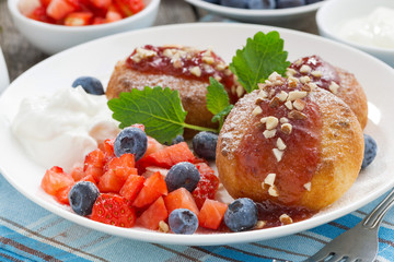 sweet cheese pancakes with berries and cream, close-up