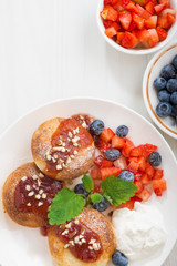 sweet cheese pancakes with fresh berries and cream 