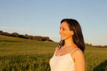 Woman looking at side relaxing on a meadow