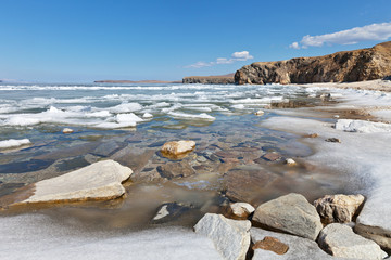 Lake Baikal. Spring sunny day. Melting ice
