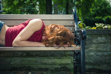 Young woman relaxing on park bench