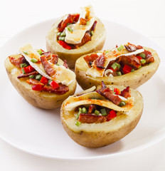 Baked potatoes stuffed with bacon, served with camembert