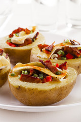 Baked potatoes stuffed with bacon, served with camembert