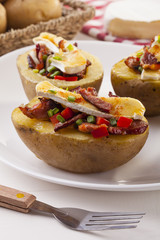 Baked potatoes stuffed with bacon, served with camembert