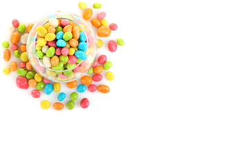 Colorful candies in glass bowl isolated on white
