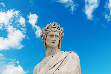 Fototapeta na wymiar alighieri statue under a blue sky with clouds
