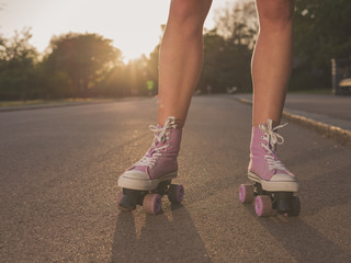 Legs of young woman roller skating in park