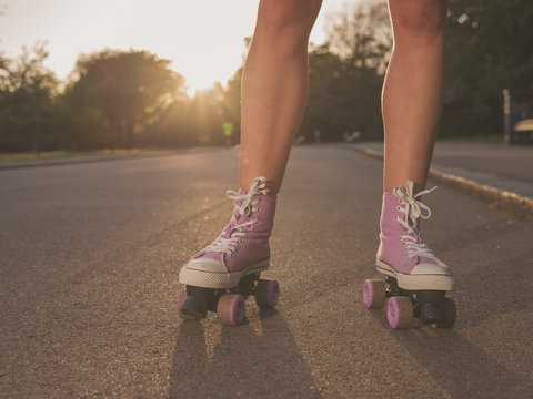 Legs of young woman roller skating in park