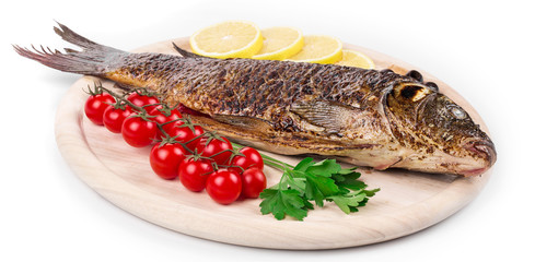 Fried carp on wooden platter.