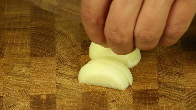 utting onions on a wooden boards background