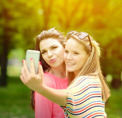 Friends making selfie on beautiful summer day in park