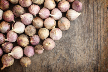 Freshly dried garlic against old wooden planks