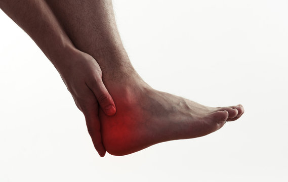 Male with foot pain or injury. Heel spur problem and therapy.  