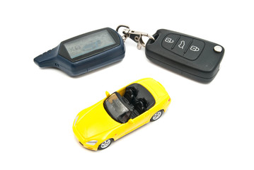 yellow car and keys on white