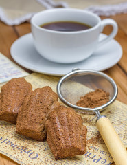 Cocoa powdered choco madeleines with a cup of coffee