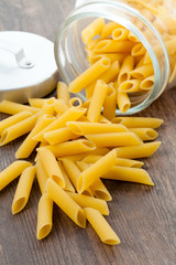 Dry pasta macaroni on wood table