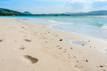 Beach with footprints on a sunny day