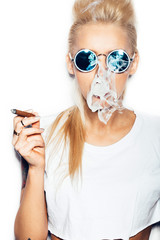 Sexy blonde woman in sunglasses smoking cigar