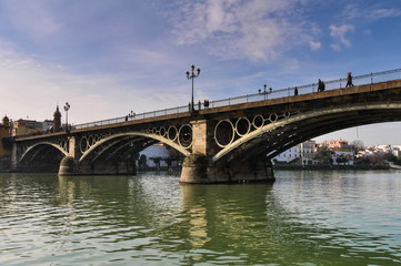 Fototapeta na wymiar Triana Bridge in Seville, Spain. The Oldest Bridge in Town