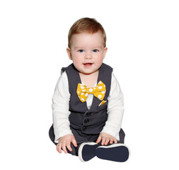 adorable baby wearing vest and bowtie looking at camera 