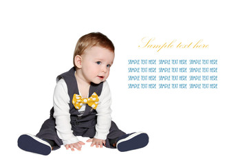 adorable baby wearing vest and bowtie looking at sample text