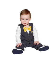 adorable baby wearing vest and bowtie on white background