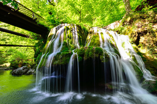 Bridge over the waterfall in the forest