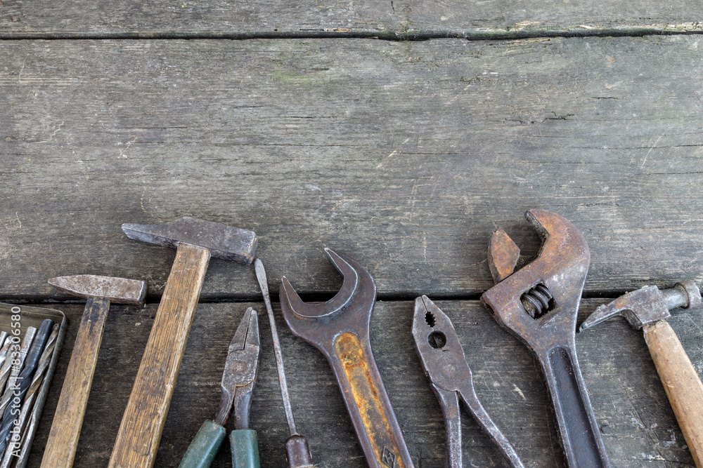 Wall mural set of antique tools on an old wood background