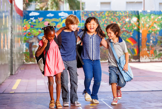 Schoolchildren embracing happy. Multi cultural racial classroom