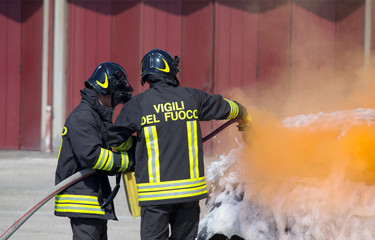 two firefighters in action with foam