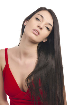 Sexy girl with long brunette hair in red dress.