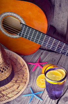 Acoustic guitar hat starfish and glass of tasty fresh lemonade
