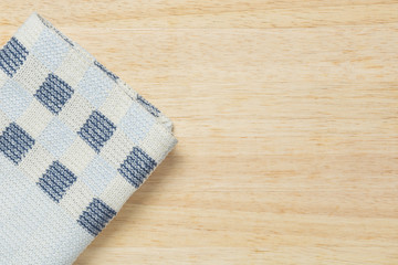 Colored fabric on wooden background.