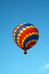 hot air balloon of primary colors flying in sky