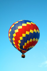 tricolored hot air balloon flying in sky