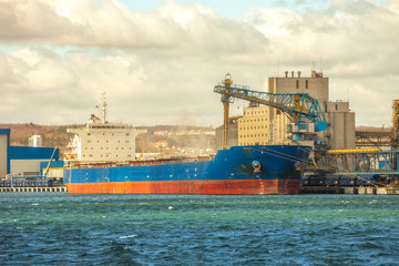 Loading cargo ship in port Gdynia, Poland.